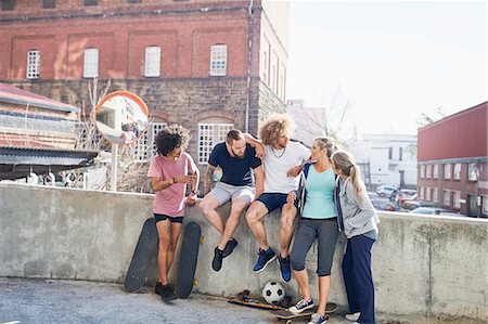 simsearch:6113-08882727,k - Friends with skateboards hanging out on urban summer wall Stock Photo - Premium Royalty-Free, Code: 6113-08882702