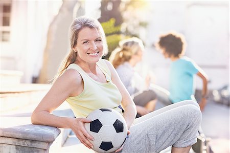 simsearch:649-05648783,k - Portrait smiling woman holding soccer ball in sunny park Stock Photo - Premium Royalty-Free, Code: 6113-08882707