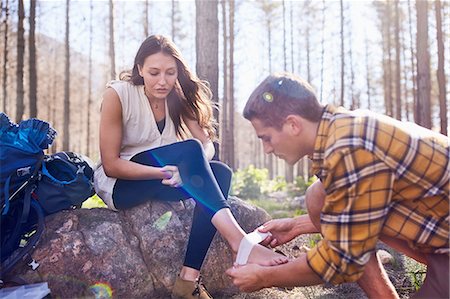 foot - Young man hiking, bandaging girlfriend’s ankle in woods Stock Photo - Premium Royalty-Free, Code: 6113-08882854
