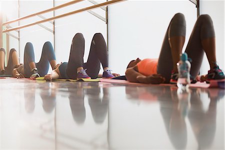 Women resting on backs in exercise class gym studio Stock Photo - Premium Royalty-Free, Code: 6113-08805398