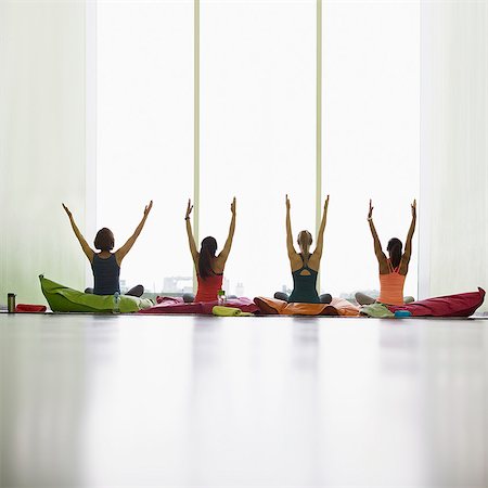 simsearch:649-08086452,k - Women on cushions with arms raised in restorative yoga gym studio Foto de stock - Royalty Free Premium, Número: 6113-08805406