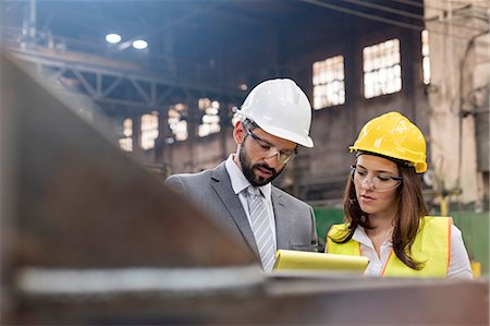 production meeting - Manager and female steel worker meeting in factory Stock Photo - Premium Royalty-Free, Code: 6113-08805548