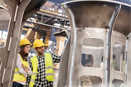 simsearch:6113-08655346,k - Steel workers examining part in factory Photographie de stock - Premium Libres de Droits, Code: 6113-08805588