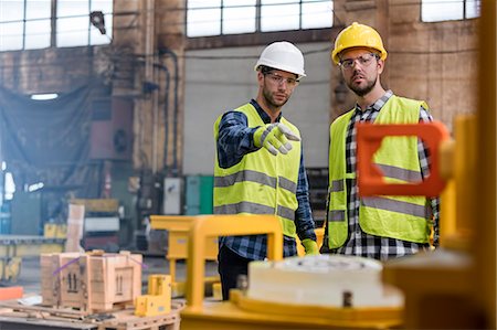 factory production - Steel workers talking and pointing in factory Stock Photo - Premium Royalty-Free, Code: 6113-08805592