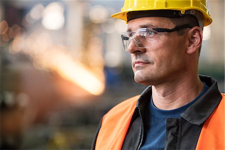 simsearch:6124-08907957,k - Close up pensive steel worker looking away Stock Photo - Premium Royalty-Free, Code: 6113-08805598