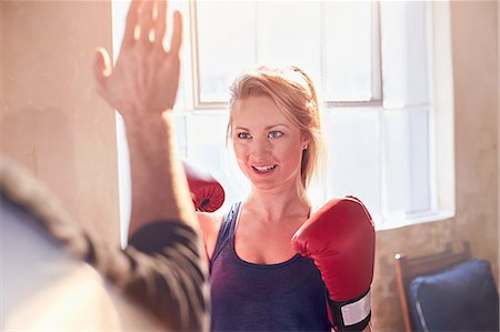 simsearch:649-06041949,k - Young female boxer practicing boxing with trainer in gym studio Fotografie stock - Premium Royalty-Free, Codice: 6113-08805523