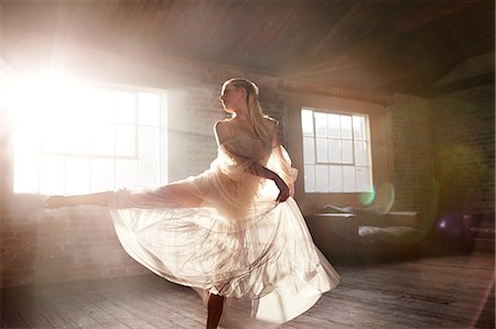 elegant dancer - Graceful female dancer dancing in sunny studio Stock Photo - Premium Royalty-Free, Code: 6113-08805527