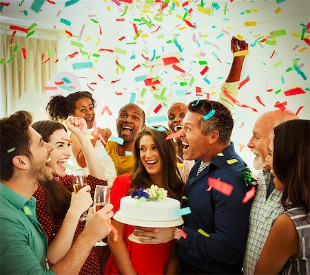 simsearch:6113-08659543,k - Enthusiastic family with birthday cake throwing confetti Foto de stock - Sin royalties Premium, Código: 6113-08805658