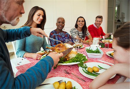 simsearch:6113-08805684,k - Family enjoying Christmas turkey dinner at table Photographie de stock - Premium Libres de Droits, Code: 6113-08805669