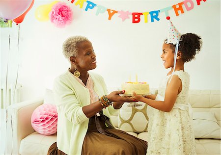 ethnic family balloons - Grandmother and granddaughter holding cake at birthday party Stock Photo - Premium Royalty-Free, Code: 6113-08805675