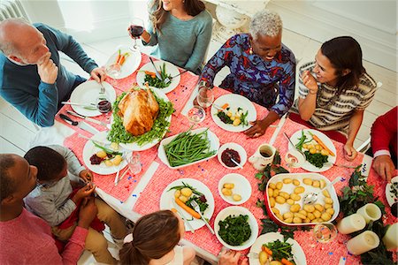 Overhead view multi-ethnic multi-generation family enjoying Christmas dinner at table Stock Photo - Premium Royalty-Free, Code: 6113-08805697