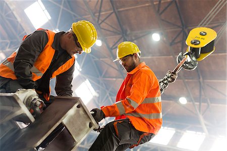 Steel workers fastening crane hook to steel in factory Stock Photo - Premium Royalty-Free, Code: 6113-08805617