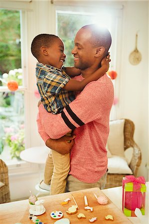 Affectionate father and son hugging next to Easter decorations Stock Photo - Premium Royalty-Free, Code: 6113-08805628