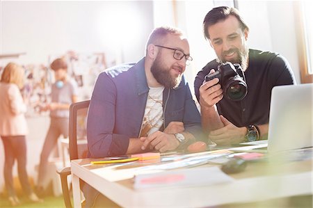 Photographer design professionals with SLR camera in office Stock Photo - Premium Royalty-Free, Code: 6113-08805854