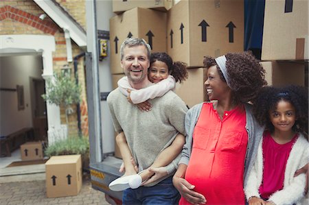 simsearch:6113-06908727,k - Portrait smiling pregnant multi-ethnic young family moving into new house Foto de stock - Sin royalties Premium, Código: 6113-08943578