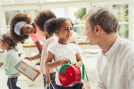 Multi-ethnic father and daughter talking Stock Photo - Premium Royalty-Free, Code: 6113-08943601