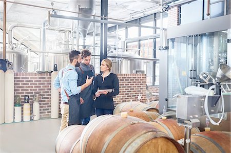 small business owner on computer not looking at camera - Brewers meeting, talking at wooden casks Stock Photo - Premium Royalty-Free, Code: 6113-08943844