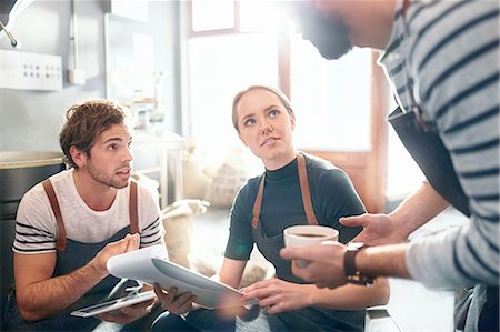 small business craft - Coffee roasters with clipboard talking and tasting coffee in meeting Stock Photo - Premium Royalty-Free, Code: 6113-08943862