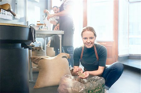 simsearch:6113-08947347,k - Portrait smiling female coffee roaster inspecting coffee beans Stock Photo - Premium Royalty-Free, Code: 6113-08943868
