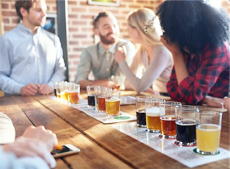 simsearch:6113-08927779,k - Friends tasting beer samples at brewery Photographie de stock - Premium Libres de Droits, Code: 6113-08943877