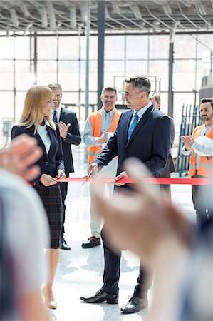 simsearch:640-02952220,k - Business people cutting ribbon at new construction site ceremony Stock Photo - Premium Royalty-Free, Code: 6113-08943899