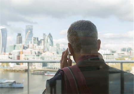 simsearch:649-06305926,k - Businessman talking on cell phone on urban balcony with city view, London, UK Photographie de stock - Premium Libres de Droits, Code: 6113-08943804