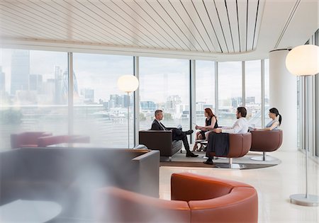 simsearch:6113-08943778,k - Business people meeting in urban highrise office lounge Photographie de stock - Premium Libres de Droits, Code: 6113-08943810