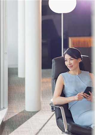 simsearch:6124-08907957,k - Businesswoman using cell phone in office lounge Stock Photo - Premium Royalty-Free, Code: 6113-08943823