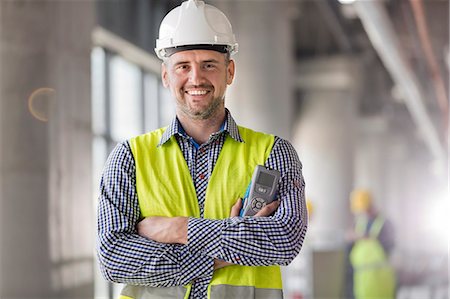 Portrait smiling engineer at construction site Fotografie stock - Premium Royalty-Free, Codice: 6113-08943944