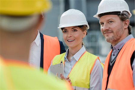 simsearch:6113-08943941,k - Smiling engineers meeting at construction site Stockbilder - Premium RF Lizenzfrei, Bildnummer: 6113-08943949