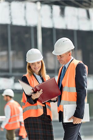 Architects reviewing paperwork at construction site Stock Photo - Premium Royalty-Free, Code: 6113-08943907