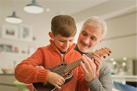 simsearch:614-02640837,k - Father teaching son to play the ukulele Stock Photo - Premium Royalty-Free, Code: 6113-08947283