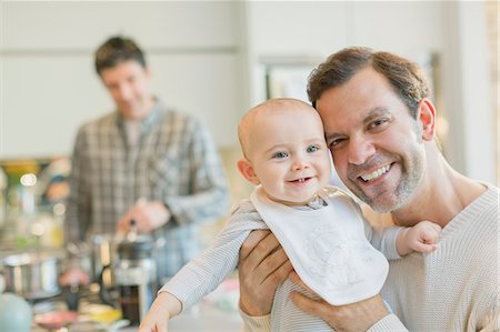 simsearch:6108-06907344,k - Portrait smiling gay father holding cute baby son Photographie de stock - Premium Libres de Droits, Code: 6113-08947217
