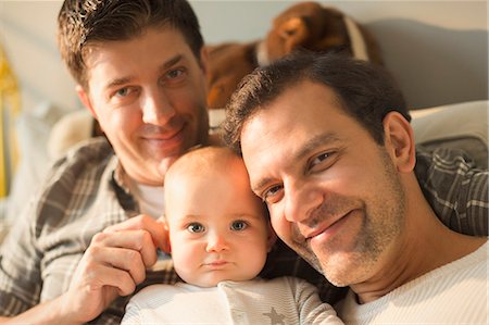 father with baby posing - Portrait smiling male gay parents and cute baby son Stock Photo - Premium Royalty-Free, Code: 6113-08947216