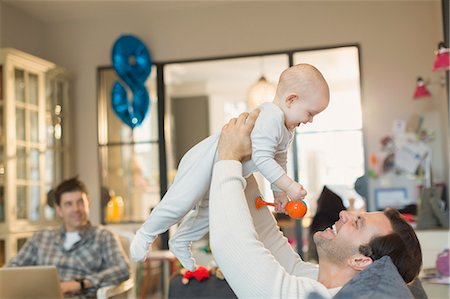 simsearch:6113-08947273,k - Male gay parents playing with baby son in living room Stock Photo - Premium Royalty-Free, Code: 6113-08947227