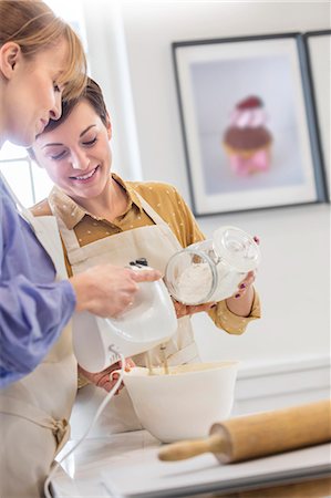 simsearch:6113-08947345,k - Women baking, using electric hand mixer in kitchen Stock Photo - Premium Royalty-Free, Code: 6113-08947364