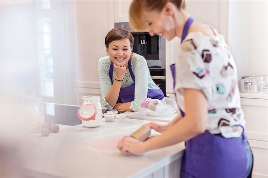 Female caterers baking, using rolling pin in kitchen Stock Photo - Premium Royalty-Free, Image code: 6113-08947369