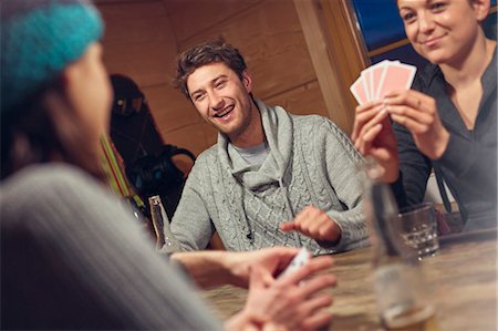 simsearch:6113-08947434,k - Friends playing cards at table in cabin Stock Photo - Premium Royalty-Free, Code: 6113-08947393