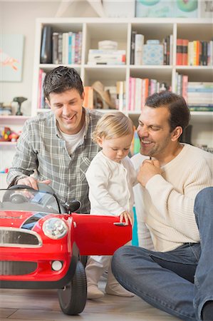 Male gay parents and baby son playing with toy car Stock Photo - Premium Royalty-Free, Code: 6113-08947322
