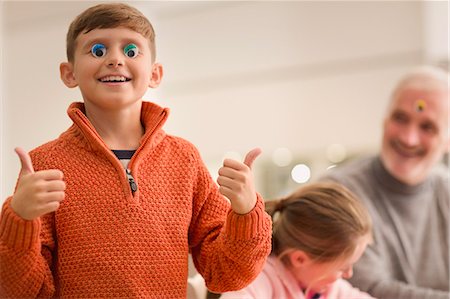 Portrait smiling playful boy gesturing thumbs-up Stock Photo - Premium Royalty-Free, Code: 6113-08947338