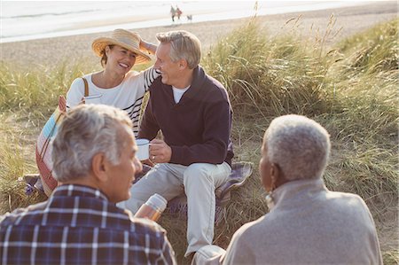 simsearch:6124-08743181,k - Senior couples drinking coffee and relaxing on beach Stock Photo - Premium Royalty-Free, Code: 6113-08985741