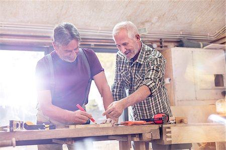 simsearch:6113-08985850,k - Male carpenters marking and measuring wood in workshop Stock Photo - Premium Royalty-Free, Code: 6113-08985840