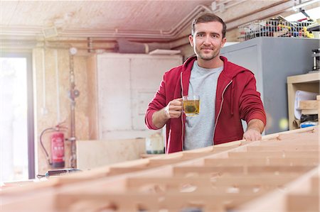 simsearch:6113-08985870,k - Portrait confident male carpenter drinking tea at wood boat in workshop Stock Photo - Premium Royalty-Free, Code: 6113-08985864