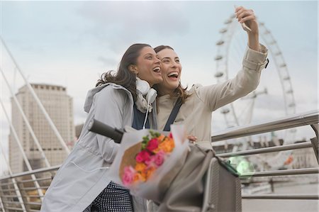 Enthusiastic, smiling women friends taking selfie with camera phone near Millennium Wheel, London, UK Photographie de stock - Premium Libres de Droits, Code: 6113-08985997