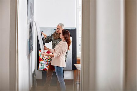 Painters examining painting in art studio Stock Photo - Premium Royalty-Free, Code: 6113-08985900