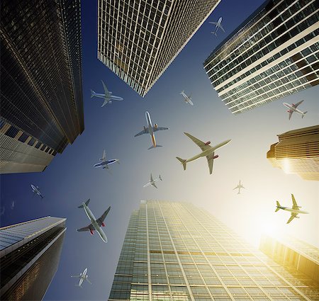 simsearch:400-08492073,k - Airplanes in blue sky above highrise buildings, travel concept Photographie de stock - Premium Libres de Droits, Code: 6113-08985928