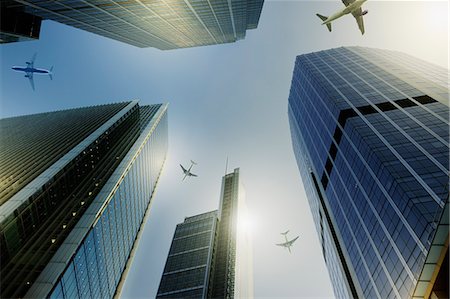 simsearch:400-08492073,k - Airplanes flying over highrise buildings, travel concept Photographie de stock - Premium Libres de Droits, Code: 6113-08985934
