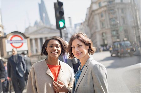 simsearch:6113-08986067,k - Portrait smiling, confident businesswomen on sunny urban city street, London, UK Foto de stock - Royalty Free Premium, Número: 6113-08986043