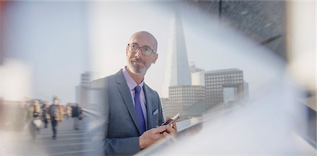 simsearch:6108-06166081,k - Pensive businessman with digital tablet, London, UK Stock Photo - Premium Royalty-Free, Code: 6113-08986093