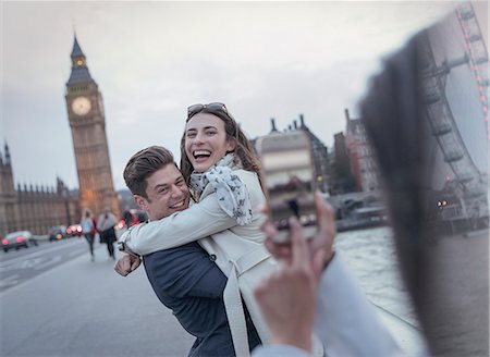 embrasser - Playful couple tourists being photographed on bridge near Big Ben, London, UK Stock Photo - Premium Royalty-Free, Code: 6113-08986007